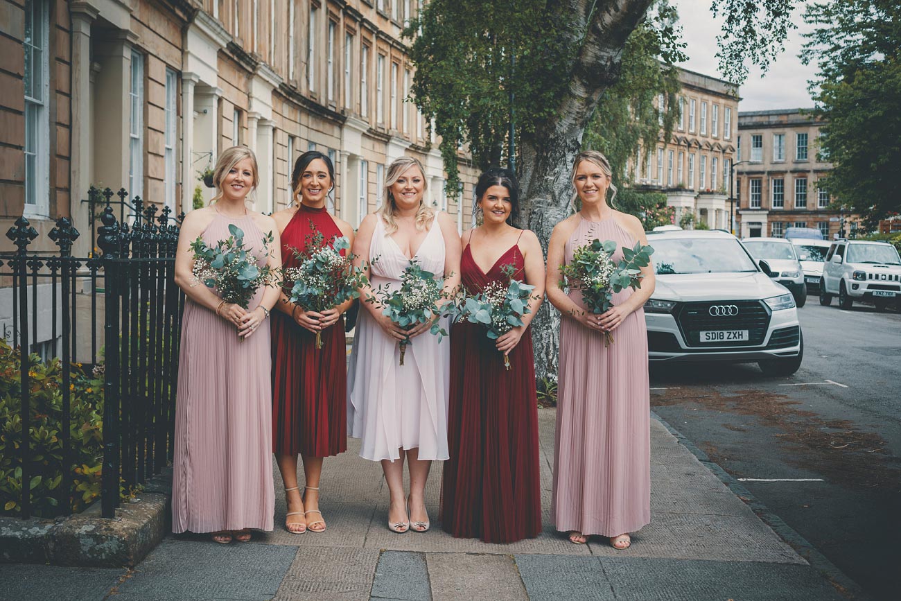bridesmaids in blush pink and red dresses